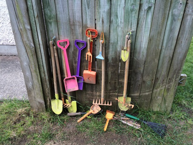 Hang sand toys on a nearby wall - easily on hand for garden play 